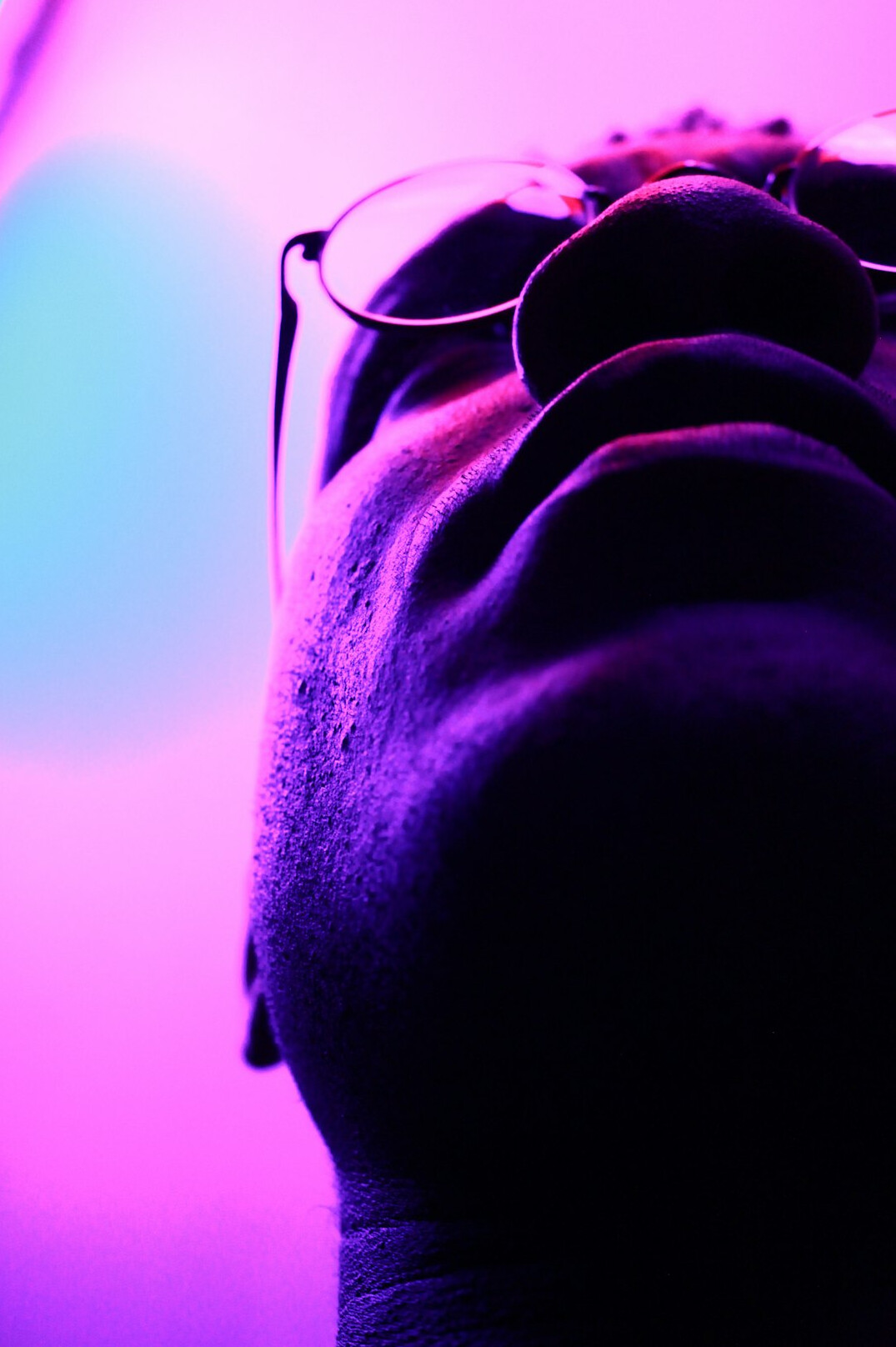 Studio photo of a man with a beard and glasses