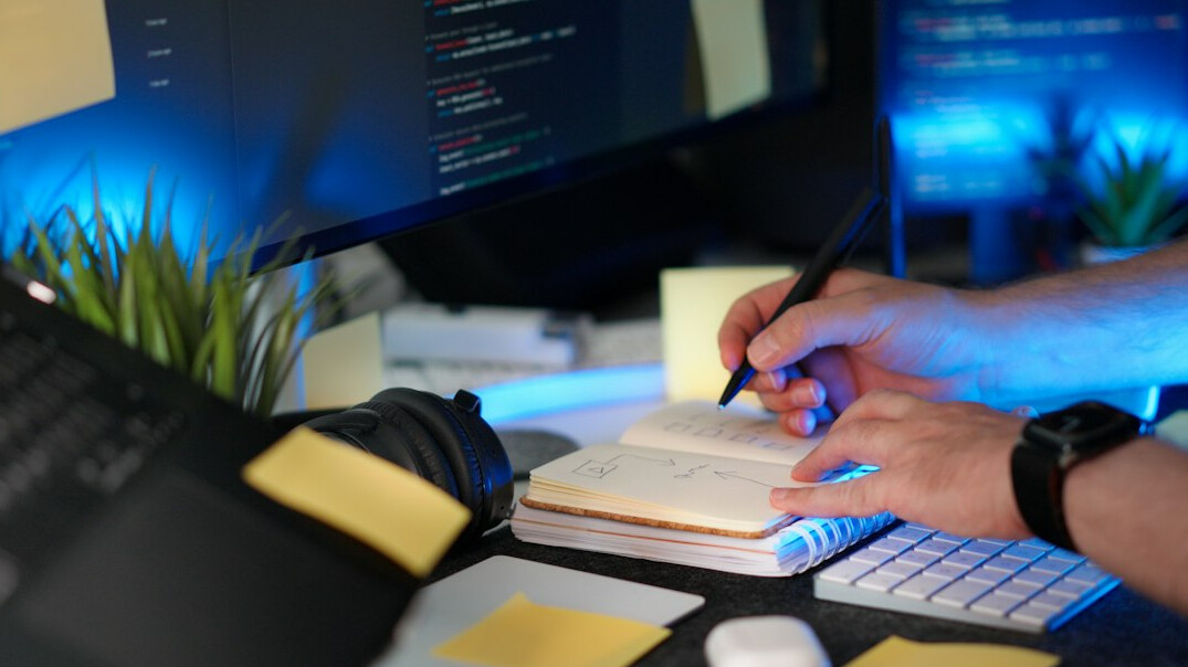 person coding at desk